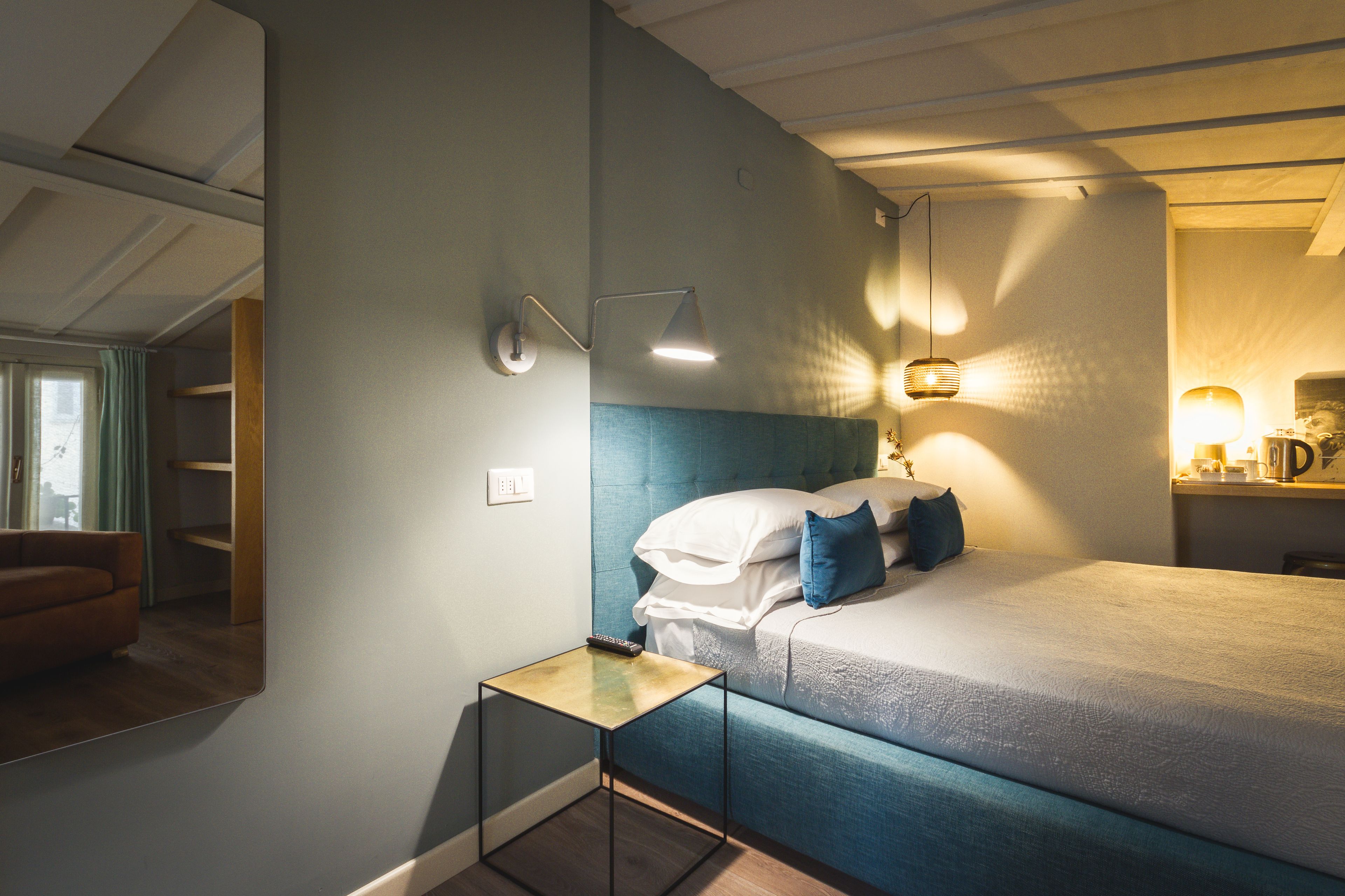 A bedroom with a bed, bedside table, and a nightstand.