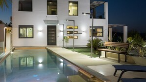 A modern two-story house with a swimming pool, outdoor lighting, and a bench. - Villa Alyona  (Platanias)