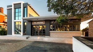 A modern building with a cafe named "The Junction" and a restaurant named "Cafe Pri". - The Junction Boutique Hotel (Plettenberg Bay)