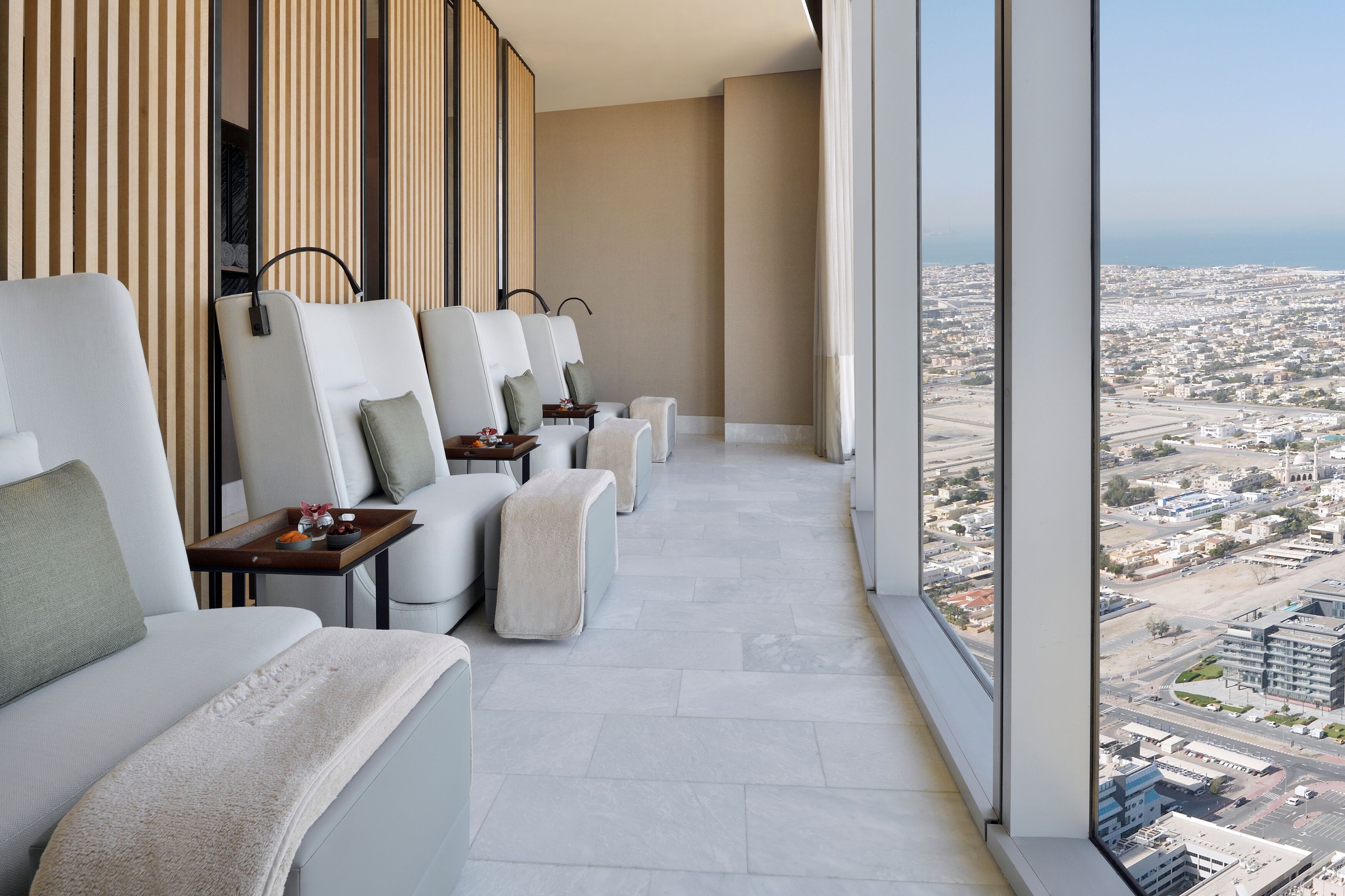 A balcony with seating and a city view.