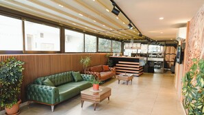A modern hotel lobby with a green sofa, wooden accents, and a reception desk. - Hayal Residence Apart Otel (Antalya)