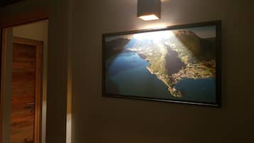 A framed map on a wall with a light above it.