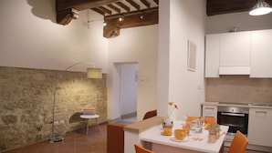 A modern kitchen with white cabinets and a built-in oven.