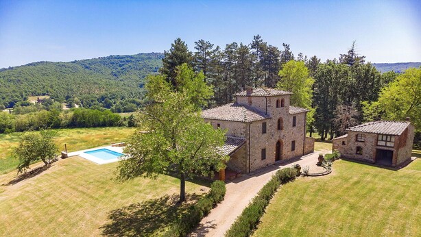 A stone building with a swimming pool, surrounded by a well-maintained lawn and trees. - Stunning private villa for 22 people with A/C, WIFI, private pool, TV, patio and panoramic view (Montebenichi)