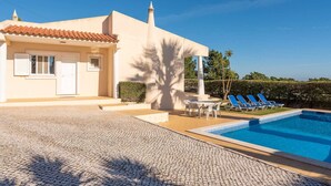 A modern villa with a swimming pool, outdoor seating, and a clear blue sky. - Villa Costa by Gabi Miguel (Sesmarias)