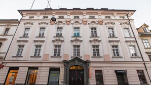 A historic building with a central entrance, multiple windows, and a sign for 'Guinness'. - Barbo Palace (Ljubljana)