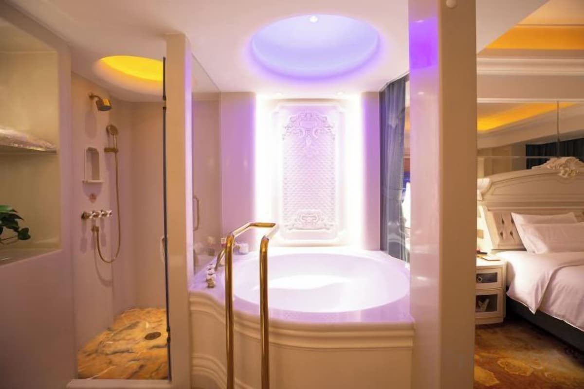 A luxurious bathroom with a large bathtub, a shower, and a vanity with a mirror.