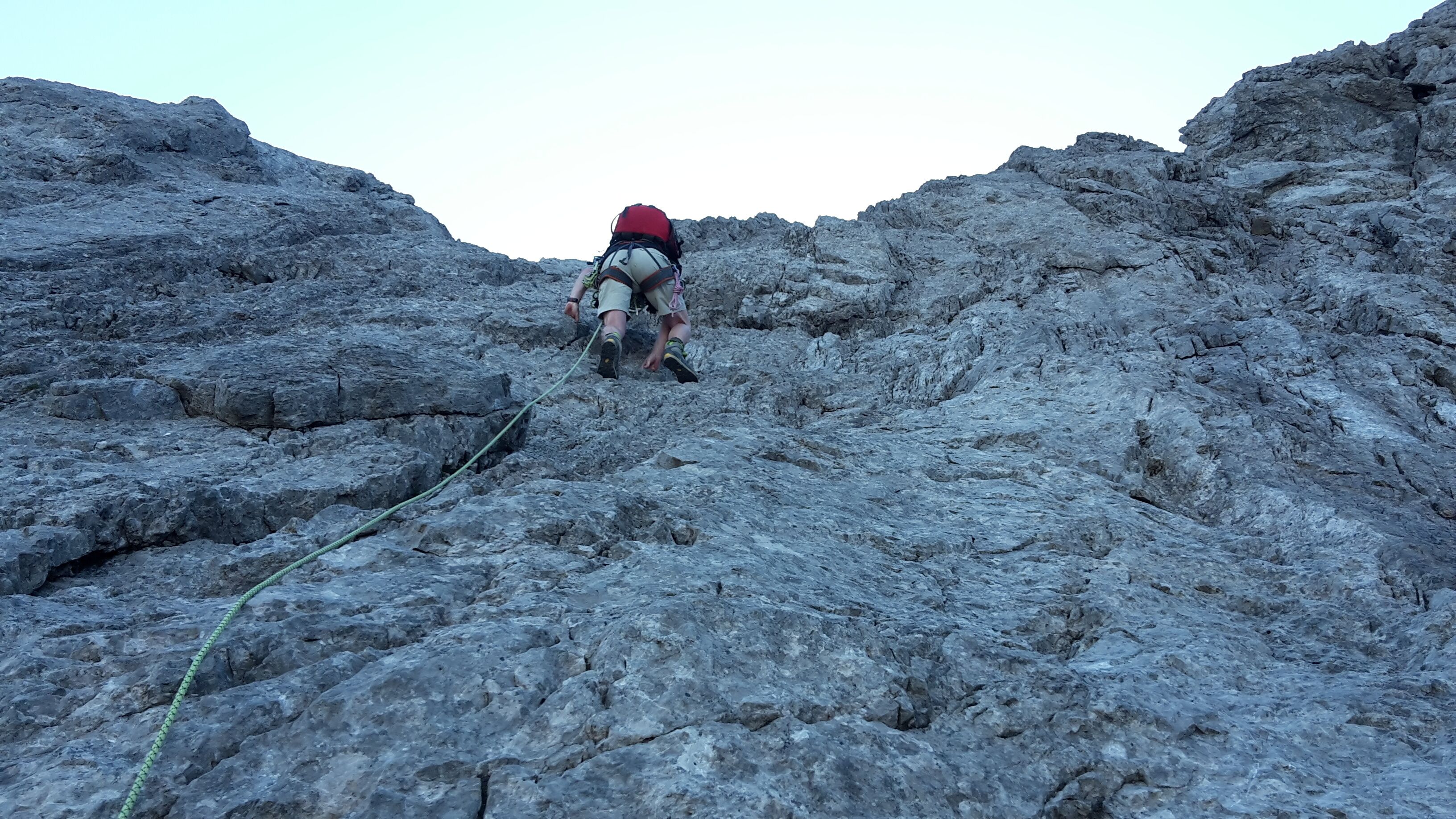 A rocky terrain with a person climbing.