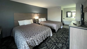 A hotel room with two beds, a desk, a TV, and a window. - Super 8 by Wyndham Sulphur South (Sulphur)