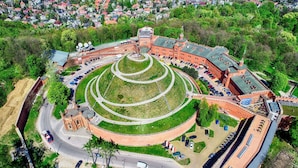 An aerial view of a historic building with a central courtyard, surrounded by a fortified wall, and adjacent residential area. - Station Apartments Kątowa 11 Krakow (Kraków)