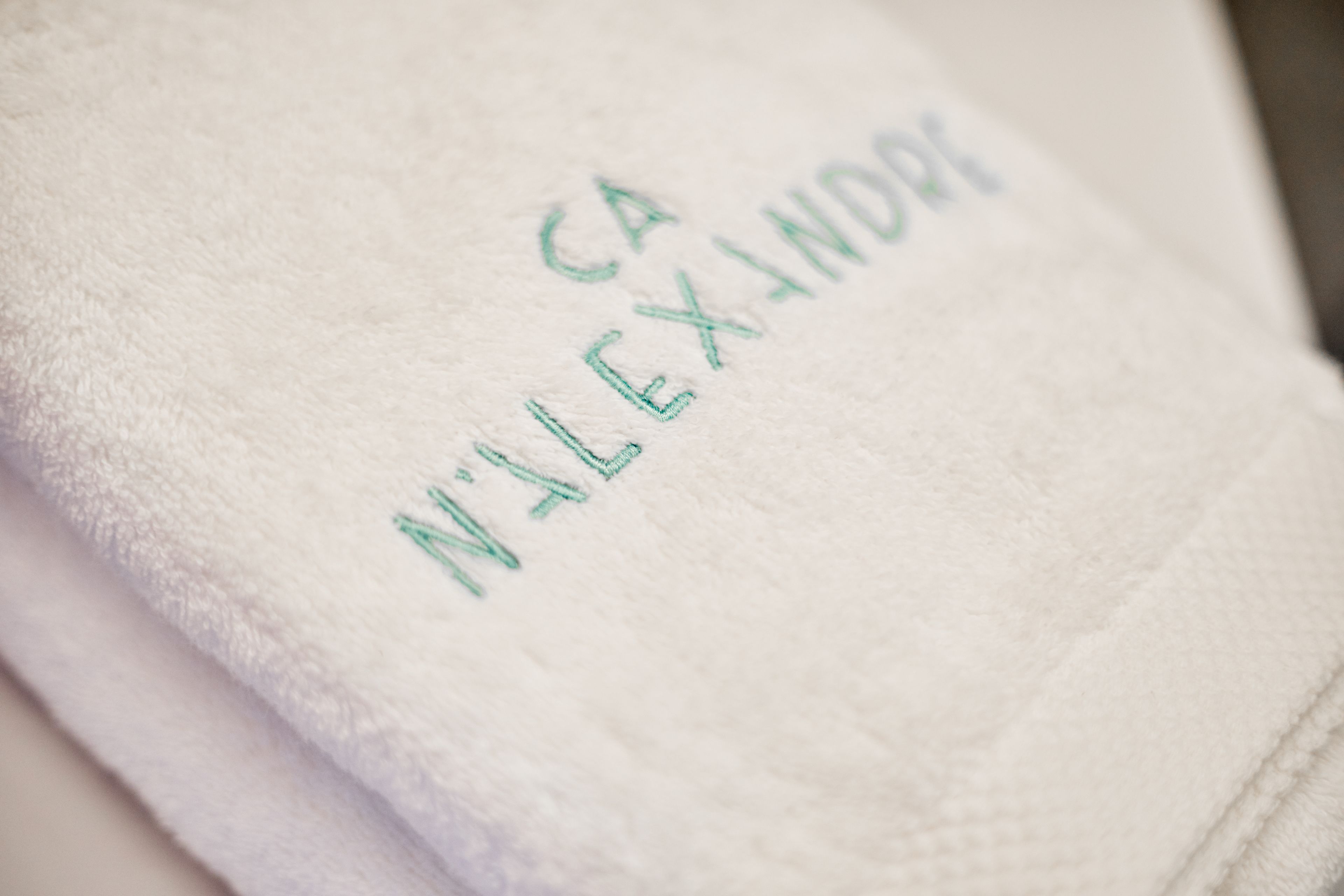 A white towel with embroidered text.