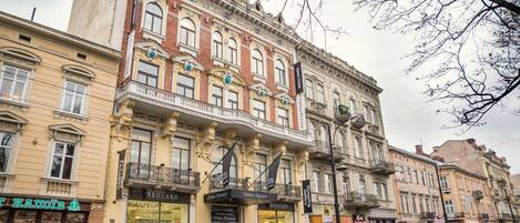 A historic building with multiple storefronts, including a theater and a bookstore.
