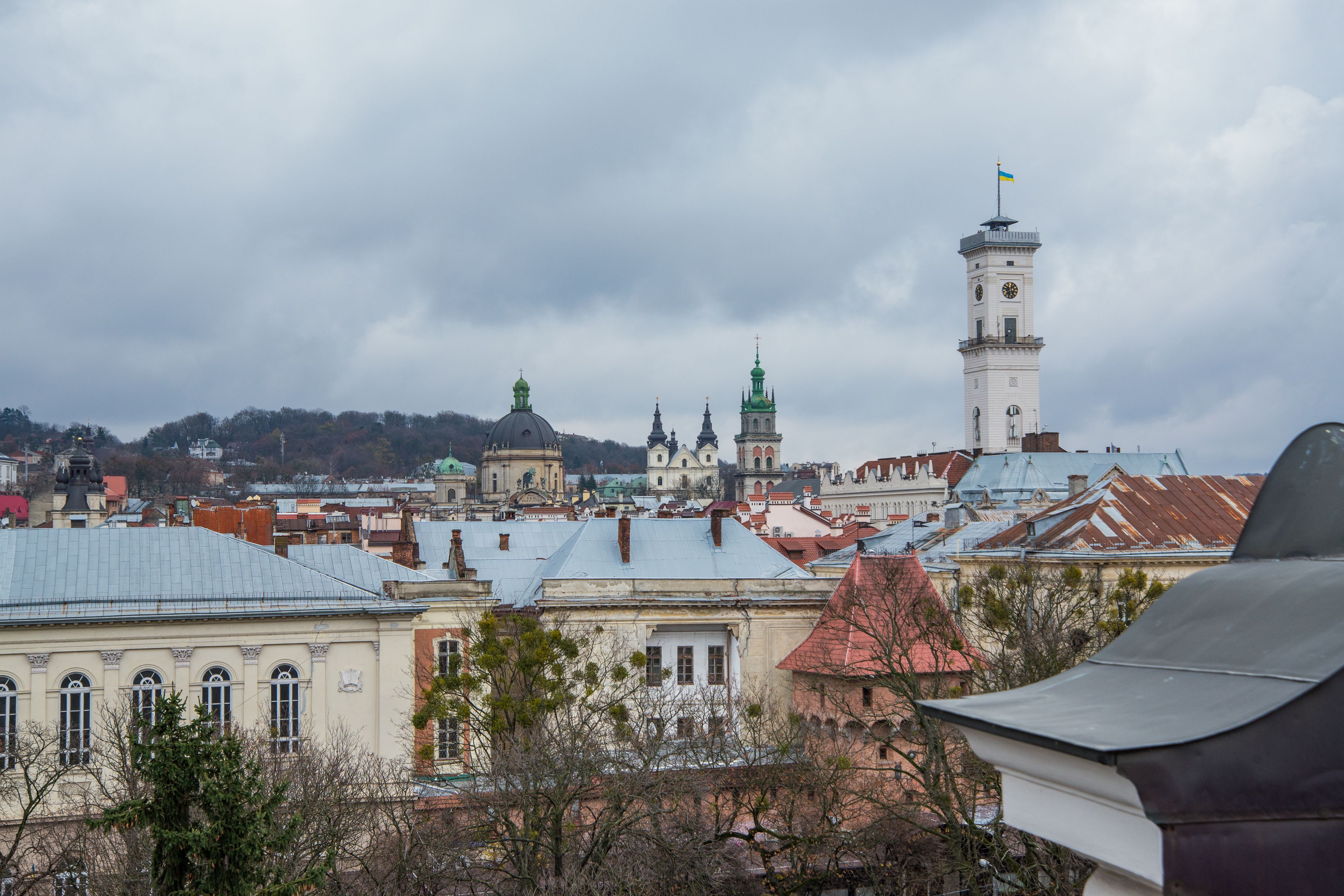 A historic cityscape with prominent architecture, including a clock tower and domed buildings.