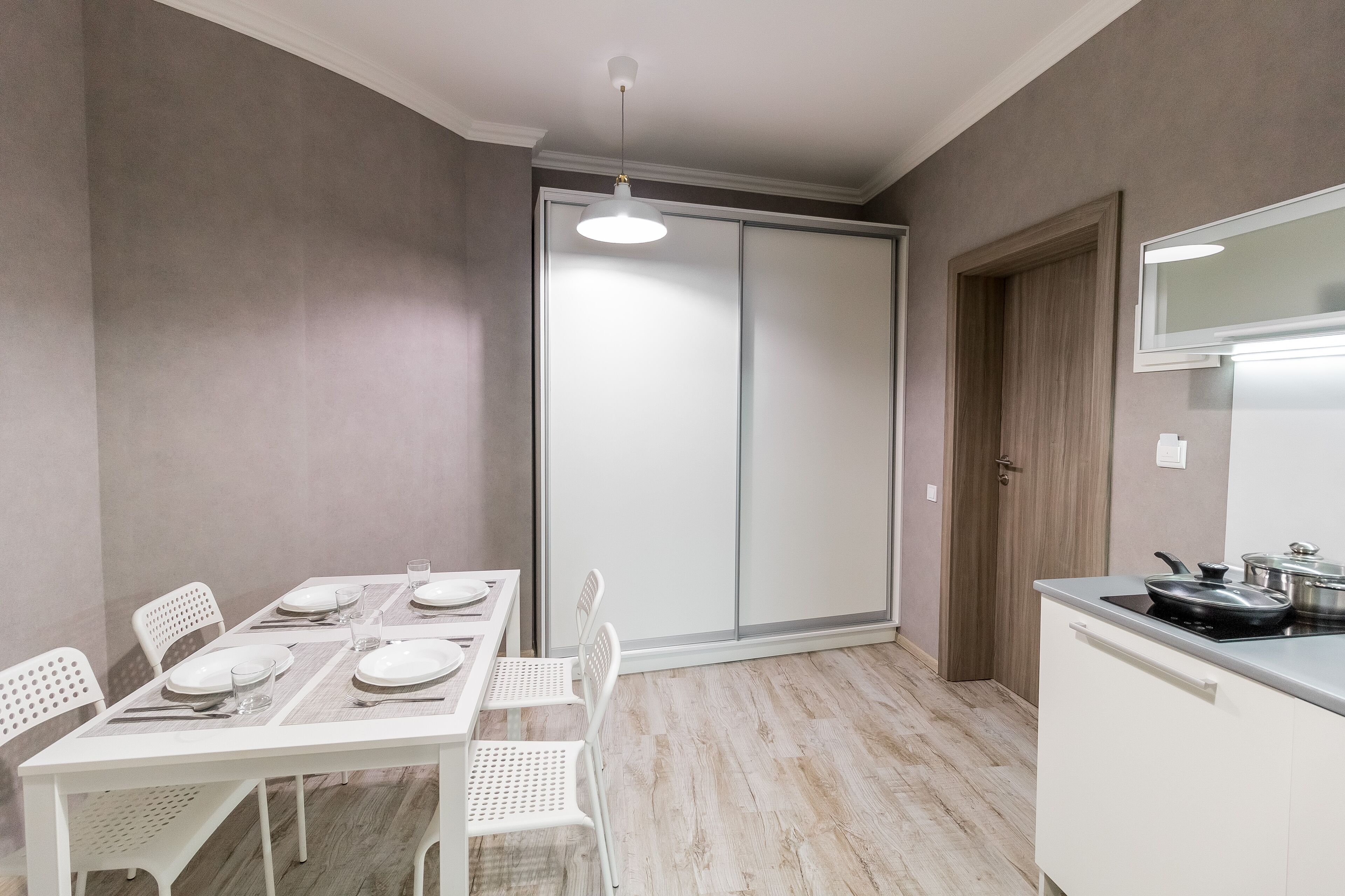A modern kitchen with a dining area.