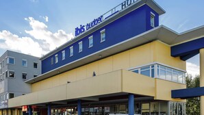 A hotel with a modern design, featuring a prominent 'ibis budget hotel' sign on the facade. - Ibis Budget Salzburg Airport (Wals-Siezenheim)