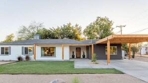 A modern two-story house with a covered patio, a well-maintained lawn, and a gravel driveway. - Modern Living, A Fav! Firepit, BBQ, Min to Airport (Phoenix)