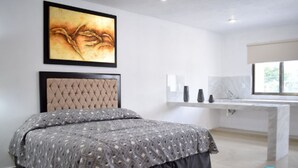 A bedroom with a bed, a headboard, a bedside table, and a window. - Hotel Apartamentos Stone (Bacalar)