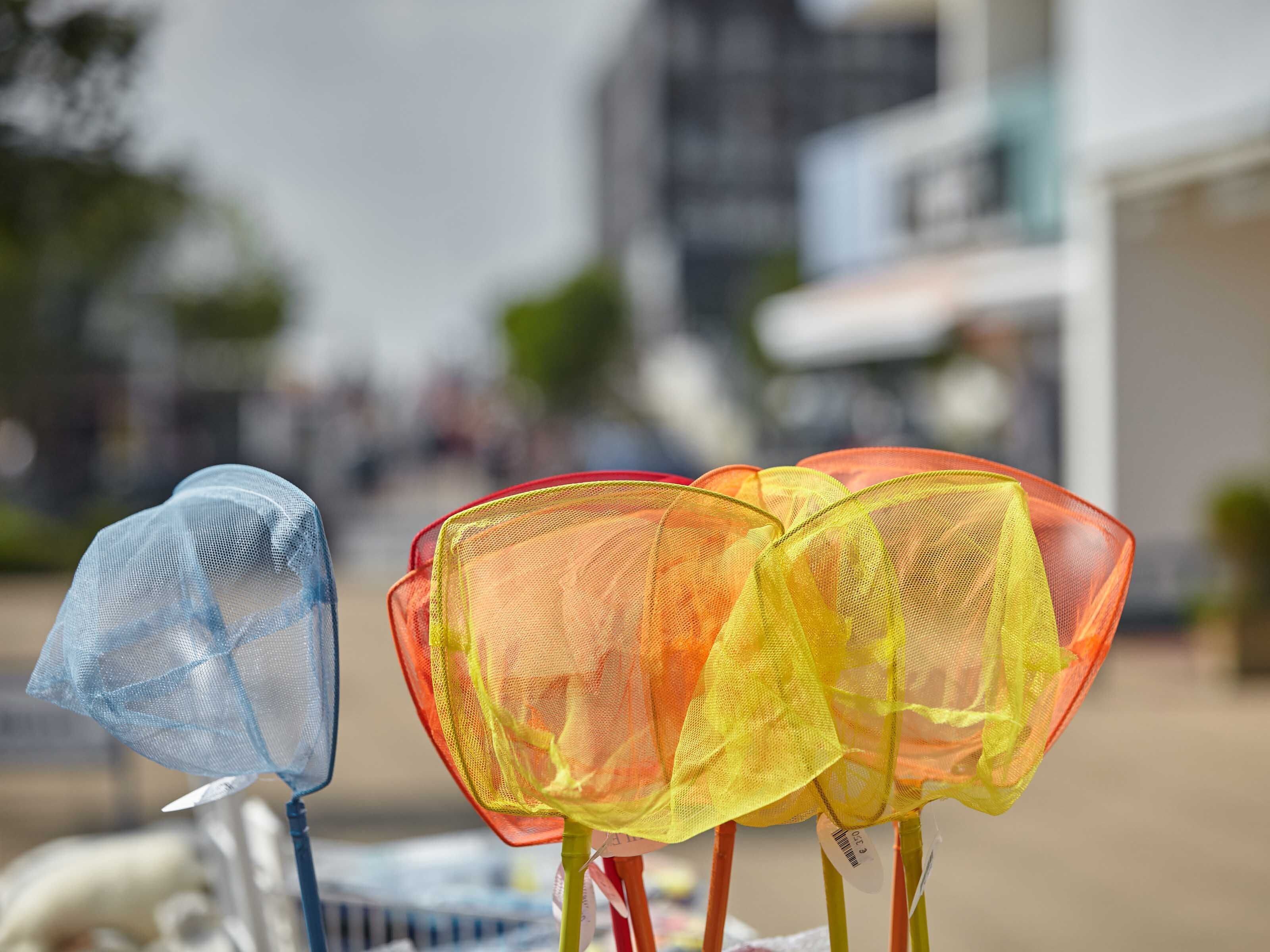 A row of colorful mesh umbrellas.