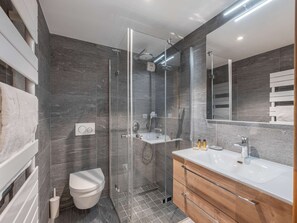 Bathtub, hair dryer, towels, toilet paper