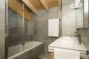Bathtub, hair dryer, towels, soap