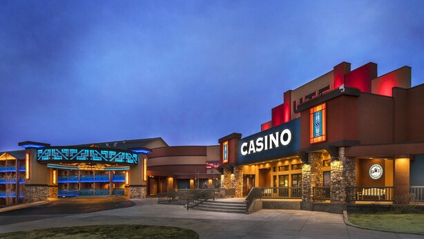A casino building with a prominent 'CASINO' sign, a modern design with stone accents, and a well-lit entrance.
