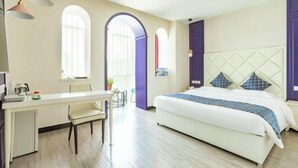 Ein Schlafzimmer mit einem Bett, einem Schreibtisch und Stühlen.