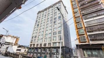 A high-rise building with multiple floors, large windows, and balconies.