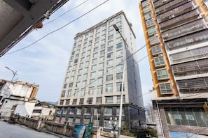 A high-rise building with multiple floors, large windows, and balconies. - Wujiang Hotel (Yanhe)