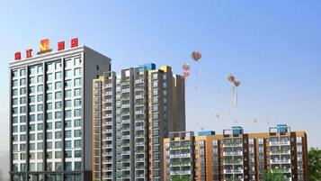 A multi-story residential building with balconies and a clear sky.