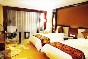 A hotel room with two beds, a desk with a computer, a chair, and a small table. - Wujiang Hotel (Yanhe)