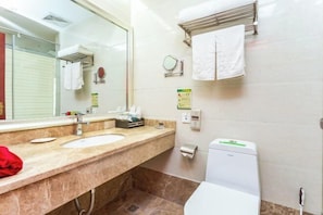 A bathroom with a sink, mirror, towel rack, and toilet. - Wujiang Hotel (Yanhe)
