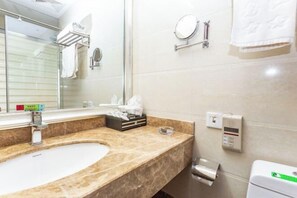 A bathroom with a sink, mirror, towel rack, and toilet. - Wujiang Hotel (Yanhe)