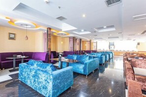 A hotel lobby with seating areas, tables, and a reception desk. - Wujiang Hotel (Yanhe)