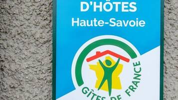 A sign for Chambres d'Hôtes Haute-Savoie, featuring a logo with a person holding a house and the text "Gîtes de France".