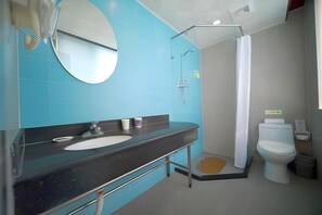 A bathroom with a black sink, a mirror, a shower with a glass door, and a toilet. - Beijing Cheap House Zhongguancun Hotel (Beijing)