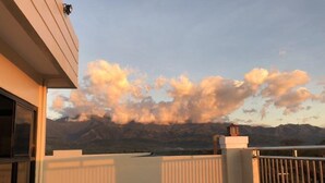 A balcony with a view of mountains and a clear sky. - Godo's Hotel and Restaurant (Culasi)