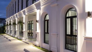 A large, white building with multiple arched windows and a symmetrical facade. - Chaanburi Boutique Resort (Chanthaburi)