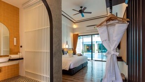 A modern hotel room with a large bed, a bathroom with a bathtub, and a view of the outside. - Chaanburi Boutique Resort (Chanthaburi)