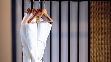A towel rack with wooden hangers and a white towel.