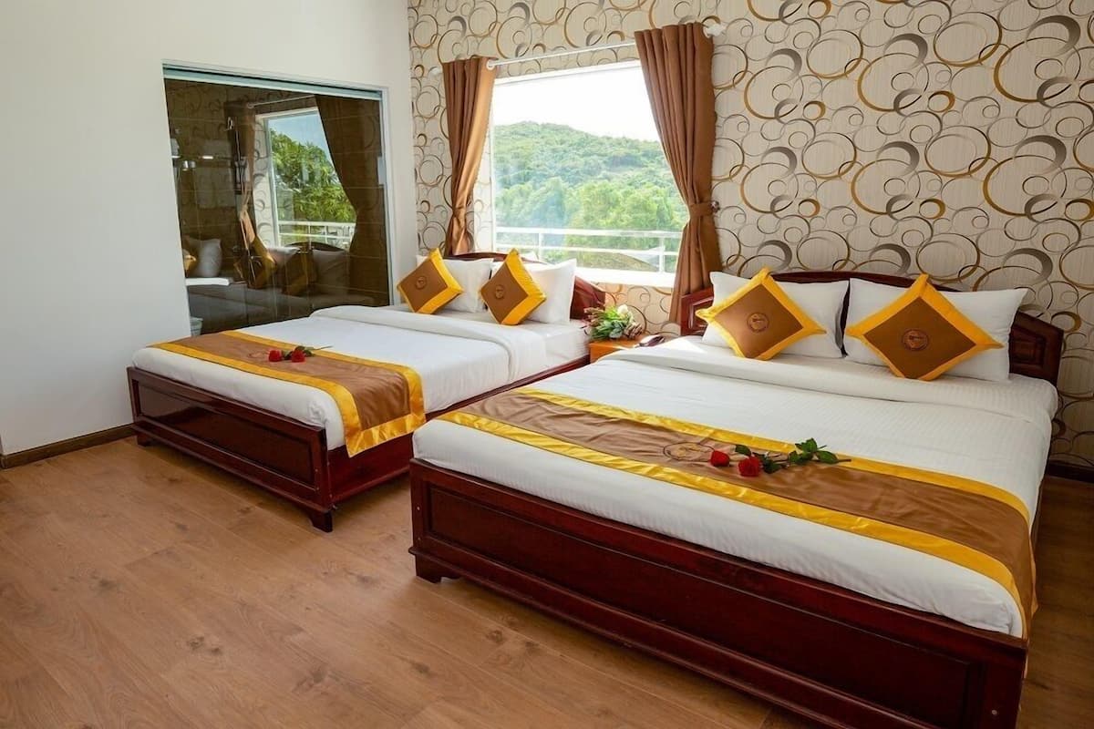 Executive Quadruple Room, Partial Sea View | Minibar, in-room safe, desk, blackout drapes