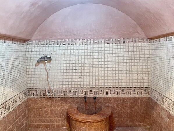 A bathroom with mosaic tile walls, a curved marble sink, and a shower area. - At the heart of Rabat Beaches (Harhoura)