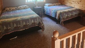 A cabin with two beds, a window, and a wooden ceiling. - Lakeside bliss and serenity in the Northwoods (Makinen)