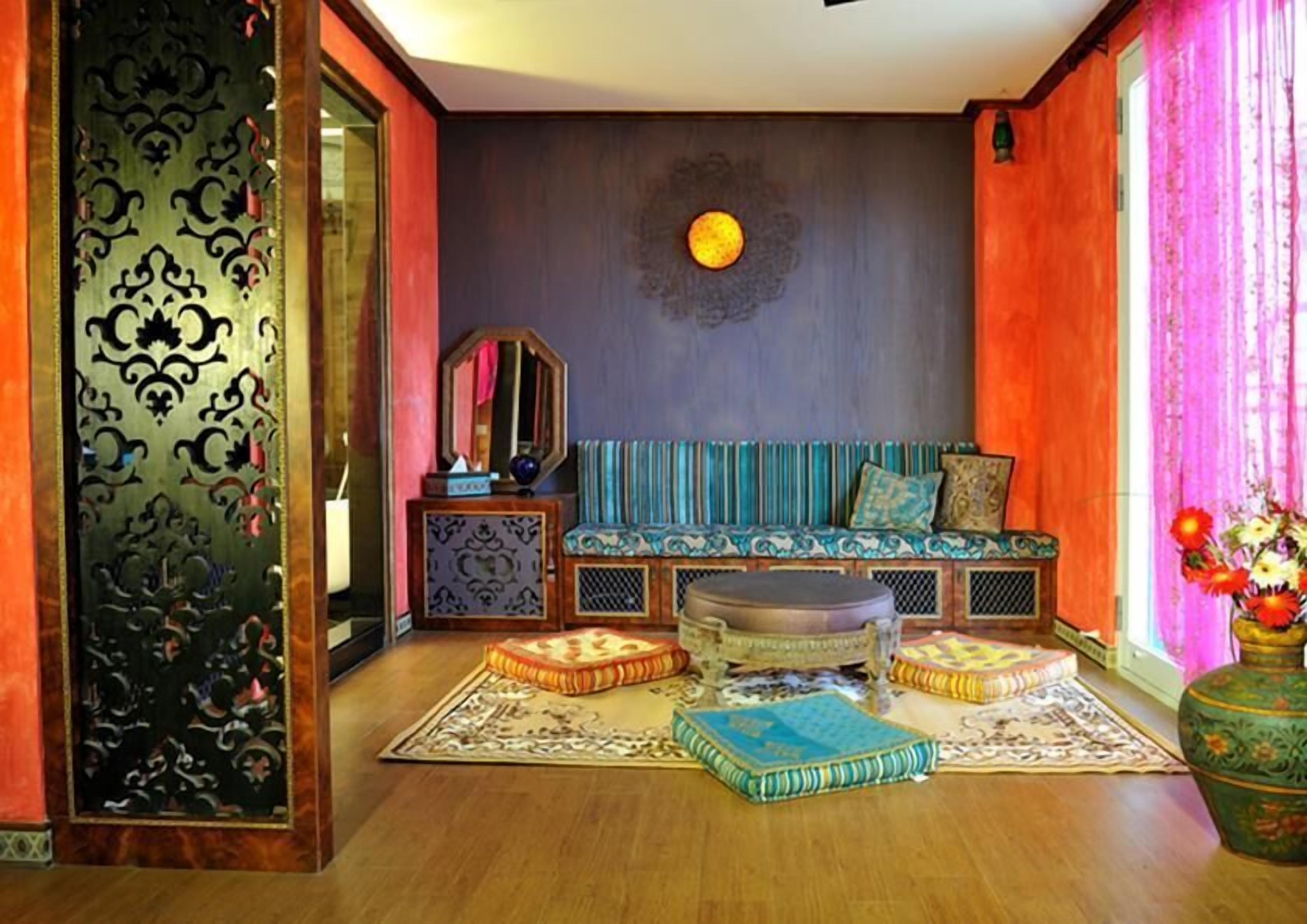 A cozy living room with a sofa, ottomans, and a coffee table.