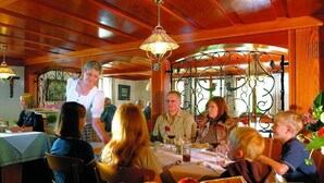 Un restaurant dont l’intérieur est en bois et qui possède des rampes en métal.