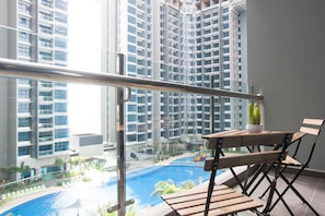 A balcony with a view of a swimming pool and high-rise buildings. - A1 BEST Atlantis Family Suites-4-6pax-Jonker Melaka (Malacca City)