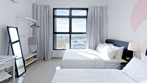A modern hotel room with a large window, a bed, a desk, and a wardrobe. - A5 FAMILY Suites 4-6pax-Atlantis-Smart TV-Melaka-WIFI (Malacca City)