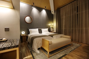 A modern bedroom with a double bed, bedside tables, a nightstand, a round mirror, and a large window with curtains. - X-Times Lakeside Hotel (Zhongshan)