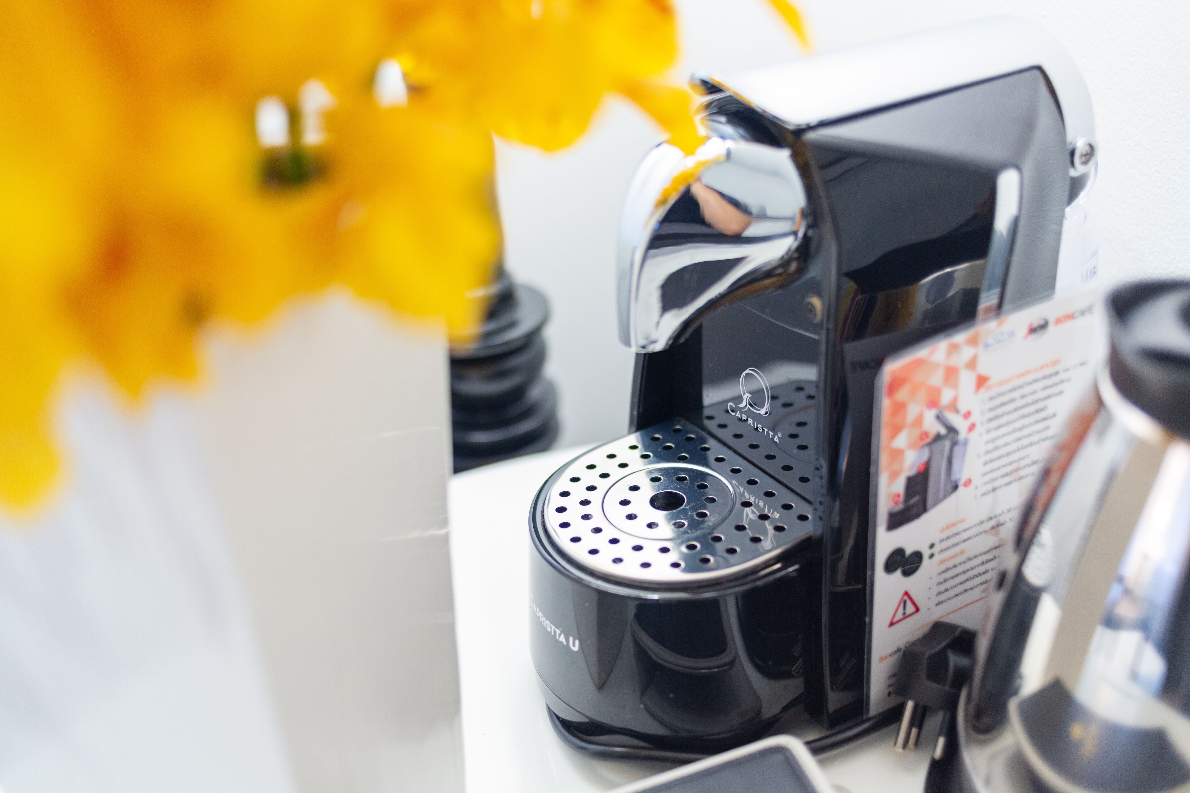 A coffee machine with a control panel and a user manual.