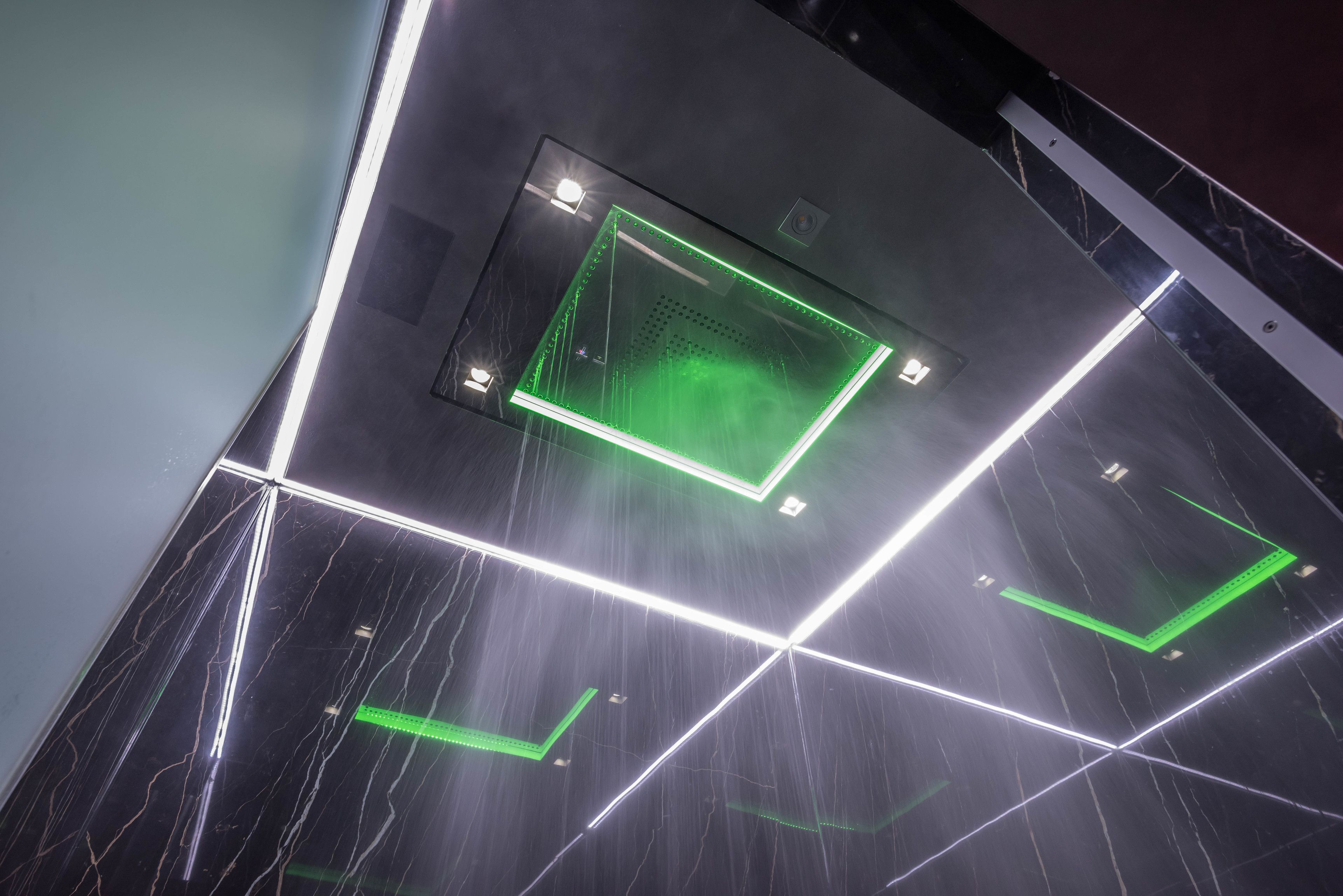 A modern interior with geometric lighting patterns and a central electronic device.