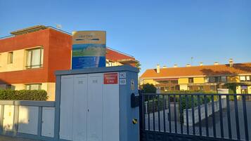 A gated entrance with a sign advertising a beach resort.